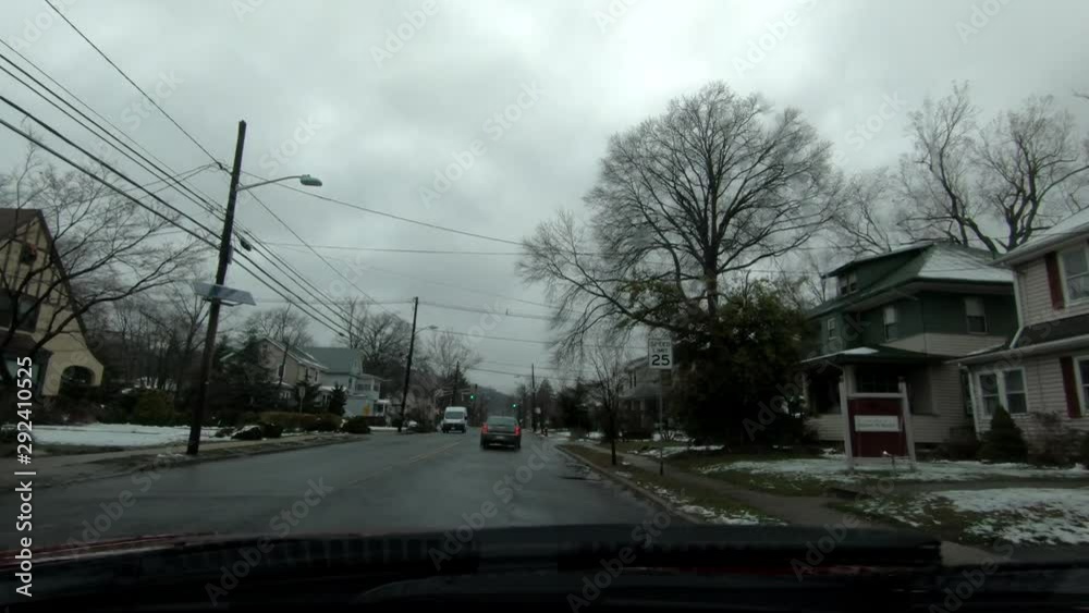 driving through suburban town on a gloomy rainy-snowy early spring day driving through suburban town on a gloomy rainy-snowy early spring day