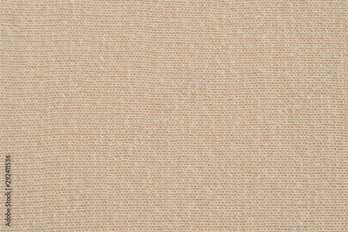 Beige knitted fabric texture. Soft jersey background. Closeup