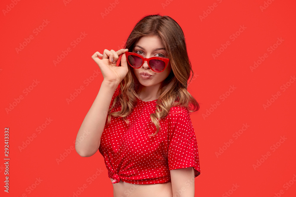 Stylish lady adjusting sunglasses and pouting lips Stylish lady adjusting sunglasses and pouting lips