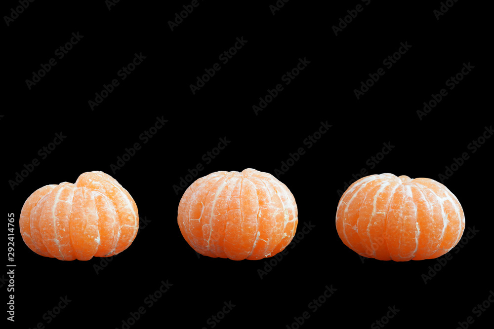 Tree different mandarins without rind isolated on black background. Side view. Copy space Tree different mandarins without rind isolated on black background. Side view. Copy space