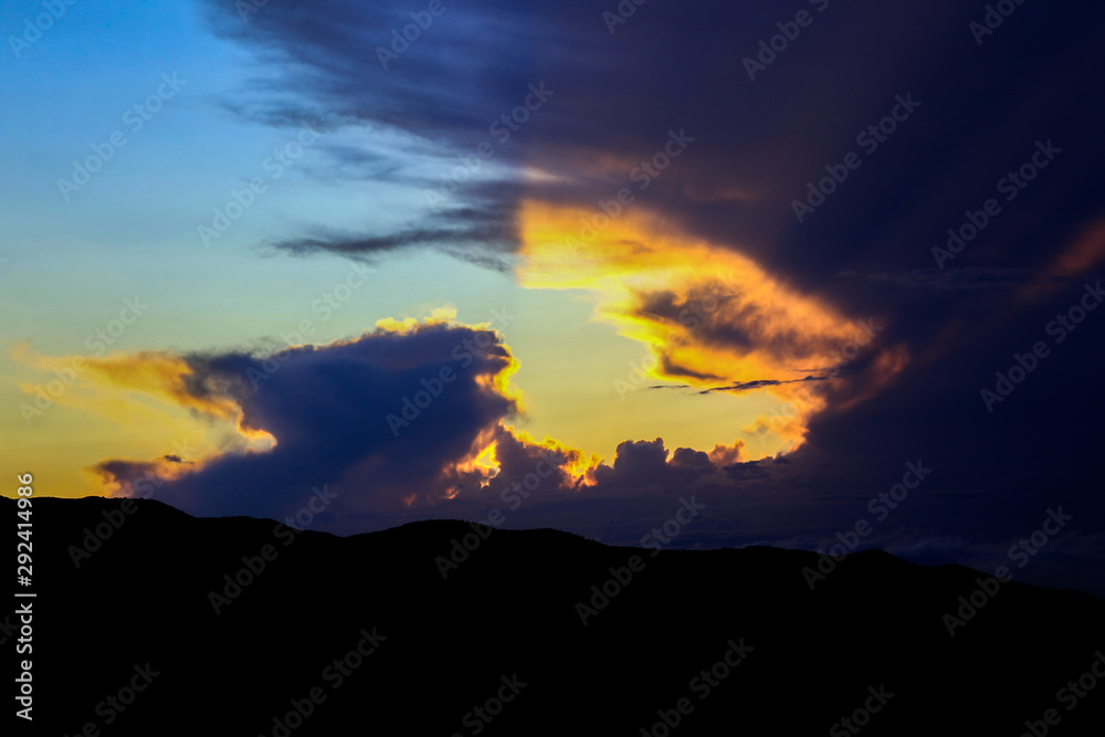 Mountains silhouette and sun rays through dark dramatic clouds. Part of set. Mountains silhouette and sun rays through dark dramatic clouds. Part of set.