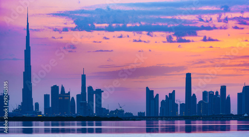 Stunning view of the silhouette of the Dubai skyline during a beautiful and dramatic sunset. Dubai is the largest and most populous city in the United Arab Emirates  UAE 