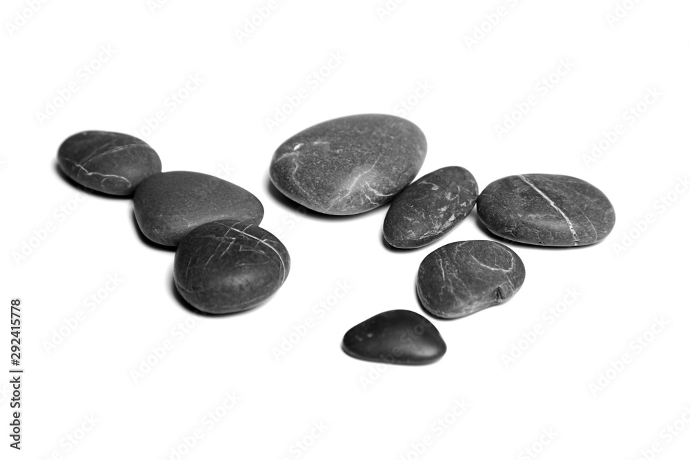 Scattered sea pebbles. Heap of smooth gray and black spa stones isolated on white background Scattered sea pebbles. Heap of smooth gray and black spa stones isolated on white background