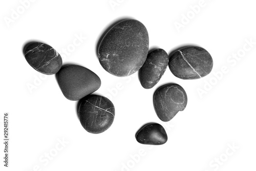 Scattered sea pebbles. Smooth gray and black spa stones isolated on white background. Top view