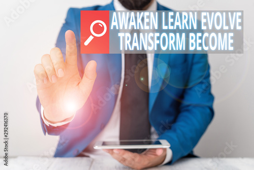 Writing note showing Awaken Learn Evolve Transform Become. Business concept for Inspiration Motivation Improve Businessman with pointing finger in front of him