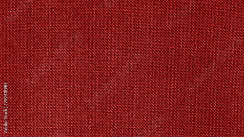 Dark red woven fabric texture background. Closeup photo