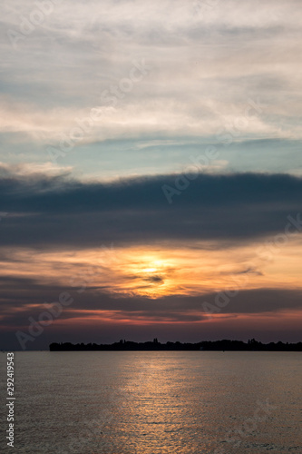 Little black spit of land into the water and a golden sunset