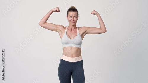 Sportswoman Flexing Arms To Camera