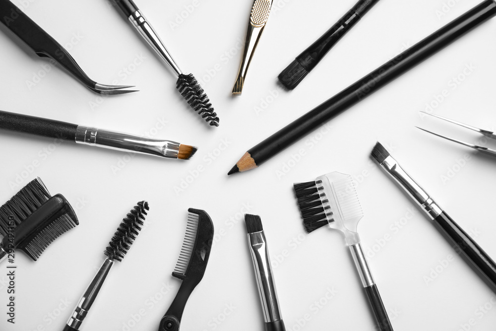 Set of professional eyebrow tools on white background, flat lay Set of professional eyebrow tools on white background, flat lay