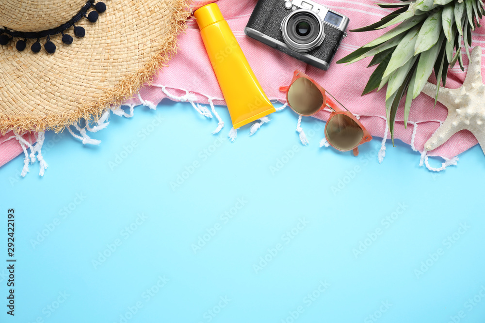 Obraz premium Flat lay composition with beach accessories on light blue background, space for text