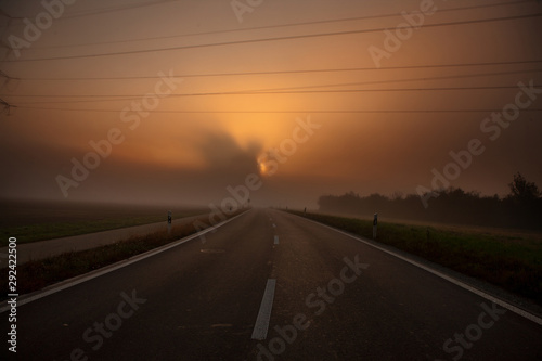energy - road during sunrise with fog
