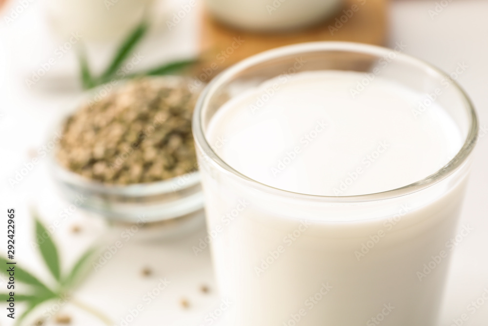 Composition with glass of hemp milk on white table, closeup. Space for text Composition with glass of hemp milk on white table, closeup. Space for text