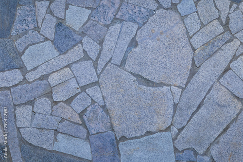a fragment of the wall of tiles of different shapes, shot on a cloudy autumn day