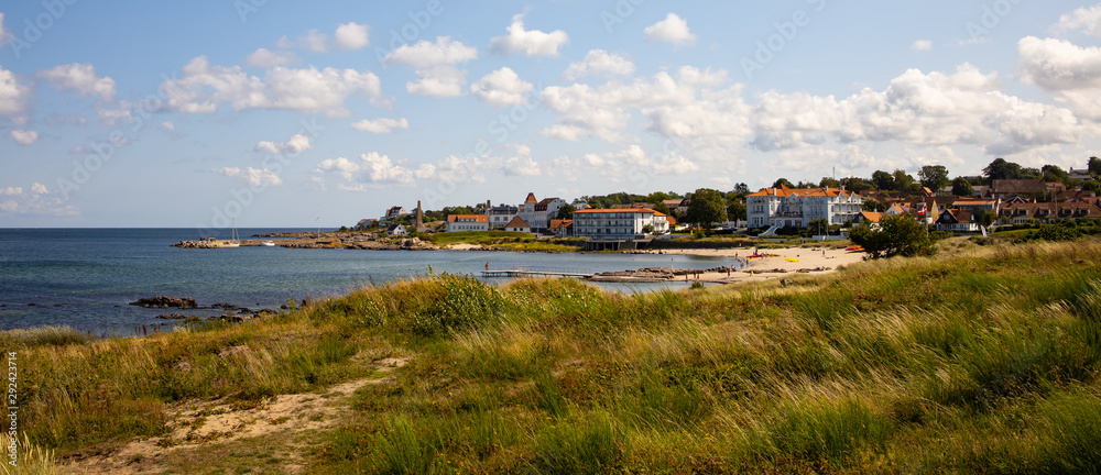 landscape with houses and blue sky, coast rocks and sea, Sandvig, Bornholm