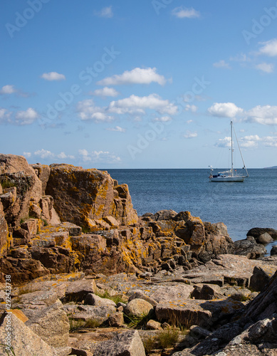 rocks and sea, sailboat, Sandvig, Bornholm photo