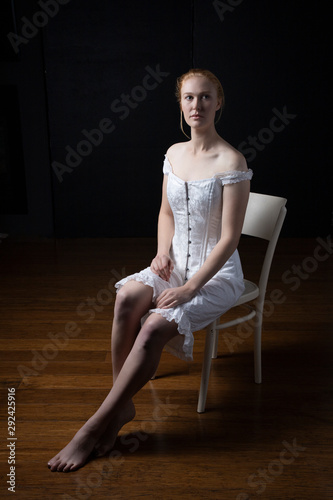фотографія Victorian woman in corset, chemise and drawers