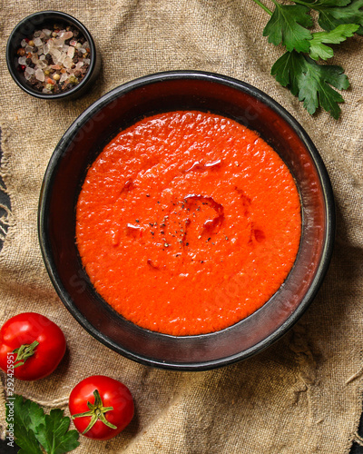 gazpacho, tomato or carrot soup with vegetables (delicious feather dish, healthy cooking) menu concept. food background. copy space. Top view