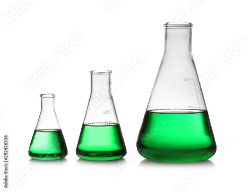 Conical flasks with green liquid on white background