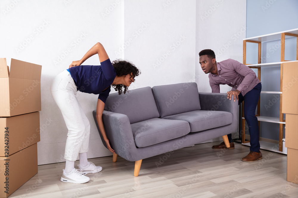 Woman Having Backpain While Lifting The Sofa Woman Having Backpain While Lifting The Sofa