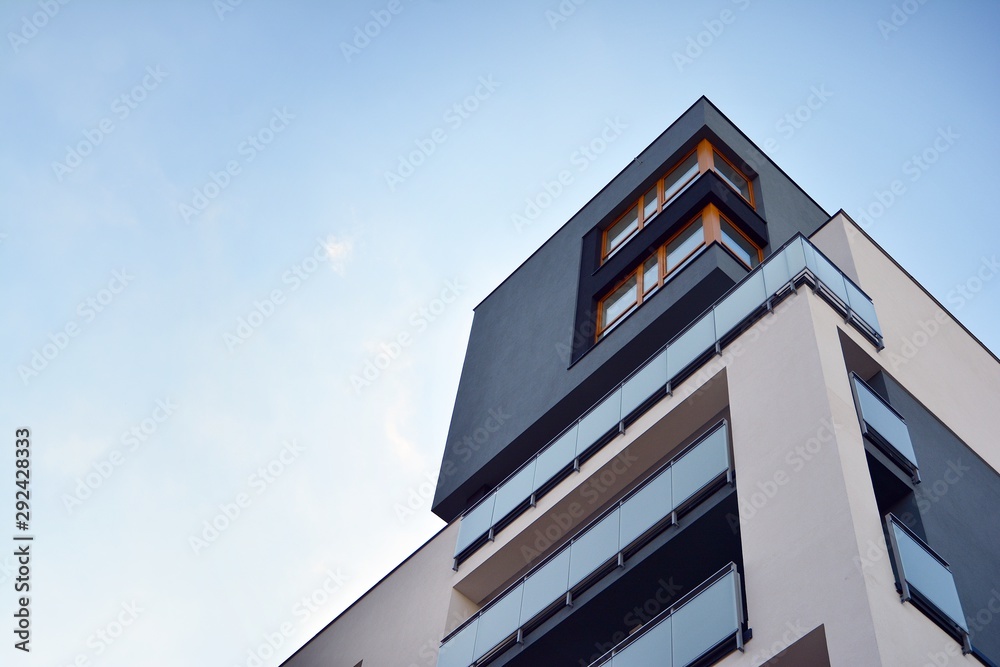 Modern apartment buildings on a sunny day with a blue sky. Facade of a modern apartment building - obrazy, fototapety, plakaty 
