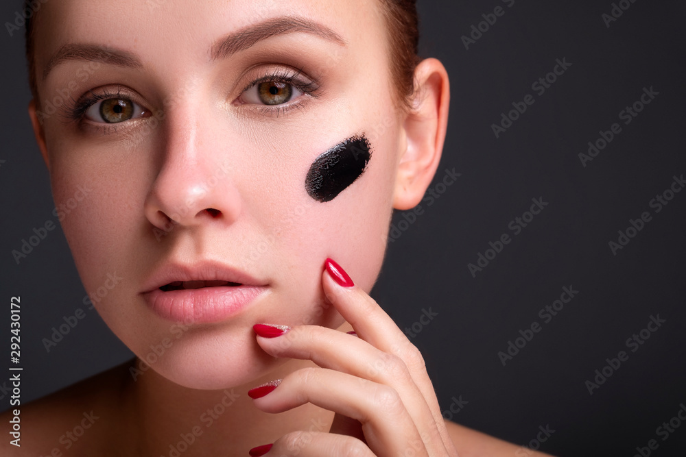 Beautiful young european woman apply clay mask on her face. beauty spa concept Beautiful young european woman apply clay mask on her face. beauty spa concept