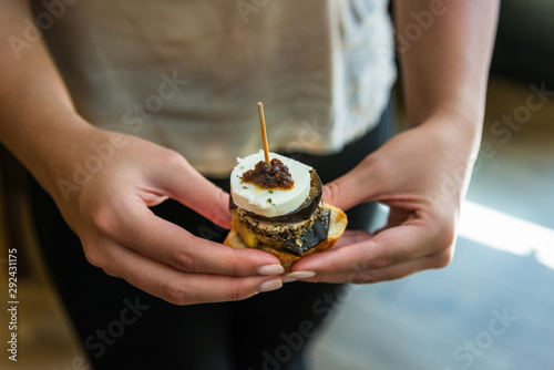 Close up photo of a tapa with goat cheese, eggplant, and marmalade