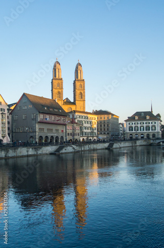 A nice day around the lake in the old city of Zurich in Switzerland  with the iconic church and the typical buildings in the background. 