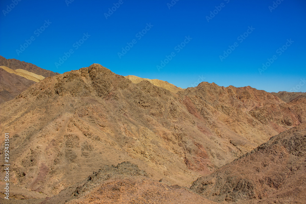 desert rocky peaks and mountain bare wilderness dangerous empty scenic landscape environment with clear blue sky background 