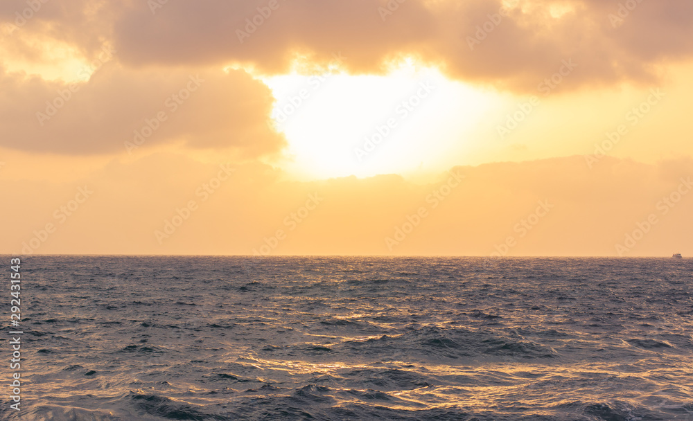 dramatic evening sunset cloudy sky above wavy sea water surface, horizon nature background simple scenery landscape 