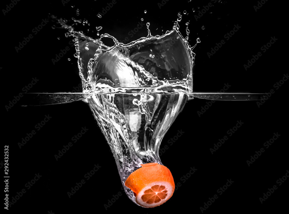 Water Splash Photography: an orange fruit falling in water creating a ...
