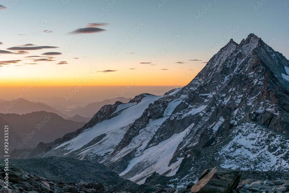 Beautiful early morning sunrise view of Portjenhorn mountain and Pizzo d'Andolla in the Weissmies Group of the Valais Alps in Switzerland. Seen from Zwischenberg Pass on the way up to Weissmies peak.