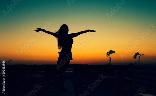 Sunset Girl on the roofs of cologne in germany - freedom