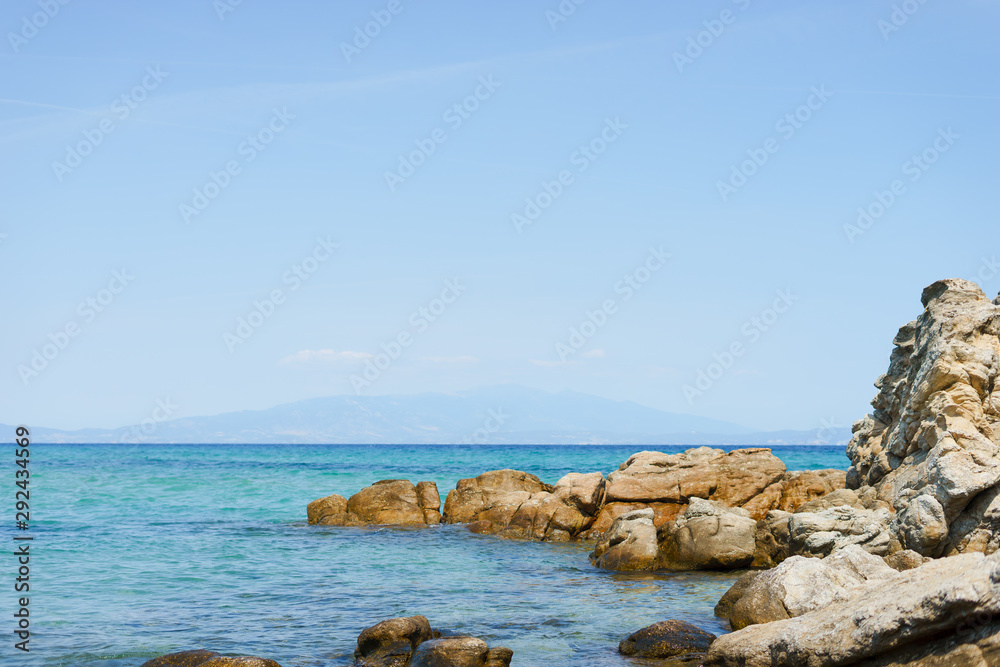 Sea horizon and rocks by the seaside in sunny day water or ocean