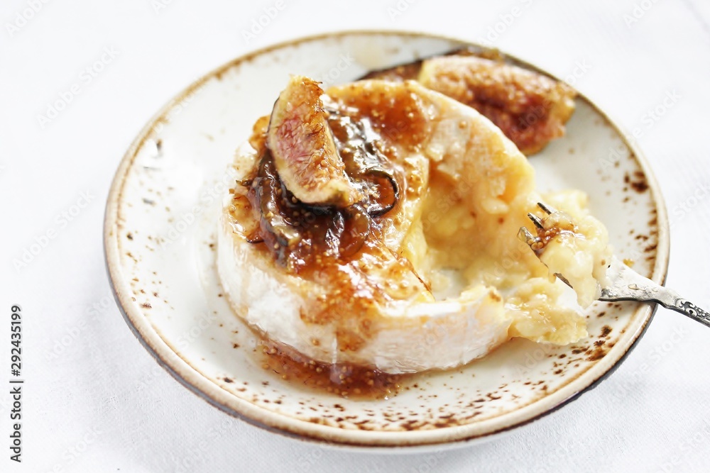 Baked Camembert cheese with fig jam and fresh figs, copy space