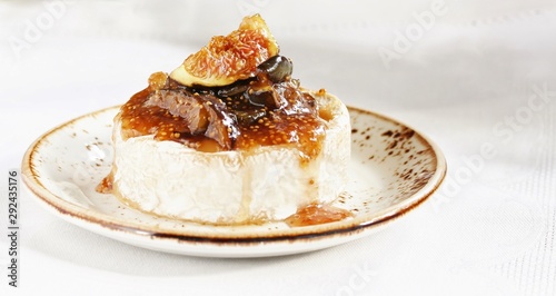 Baked Camembert cheese with fig jam and fresh figs, copy space