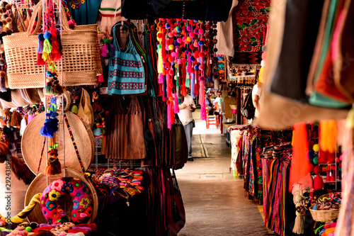 traditional Mexican street market with colorful clothes and crafts