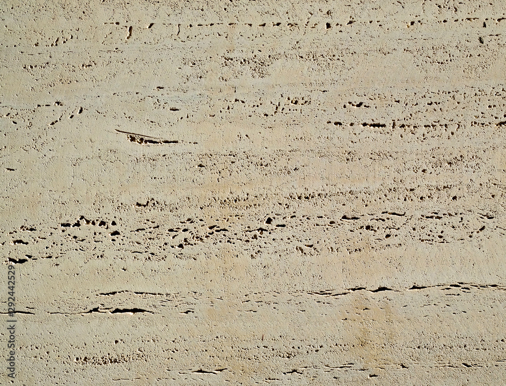 Marble surface with visible mineral inclusions and texture left by the cutting tool. Marble surface with visible mineral inclusions and texture left by the cutting tool.