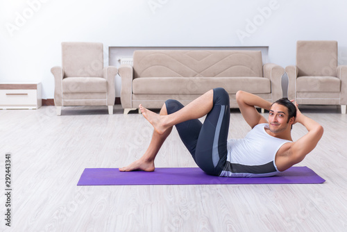 Young man training and exercising at home