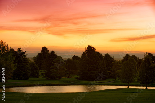 Beautiful Sunrise Clouds over trees and golf course