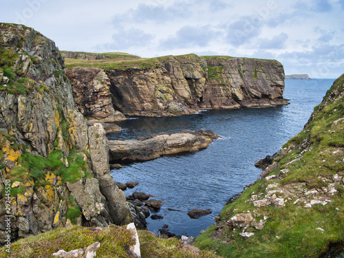 Sandstone cliffs on the East Shetland coast near Levenwick showing eroded rock strata - the bedrock is part of the Bressay Flagstone Formation, consisting of Sandstone and Argillaceous rocks, interbed