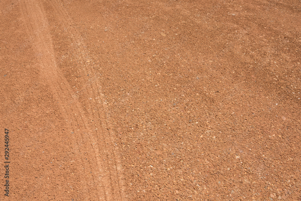 Wheel print on yellow muddy road surface background copy space