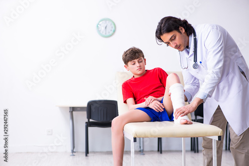 Leg injured boy visiting young doctor traumatologist