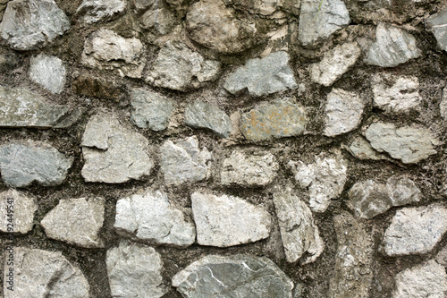 Old rough stone wall. Rock gray background.