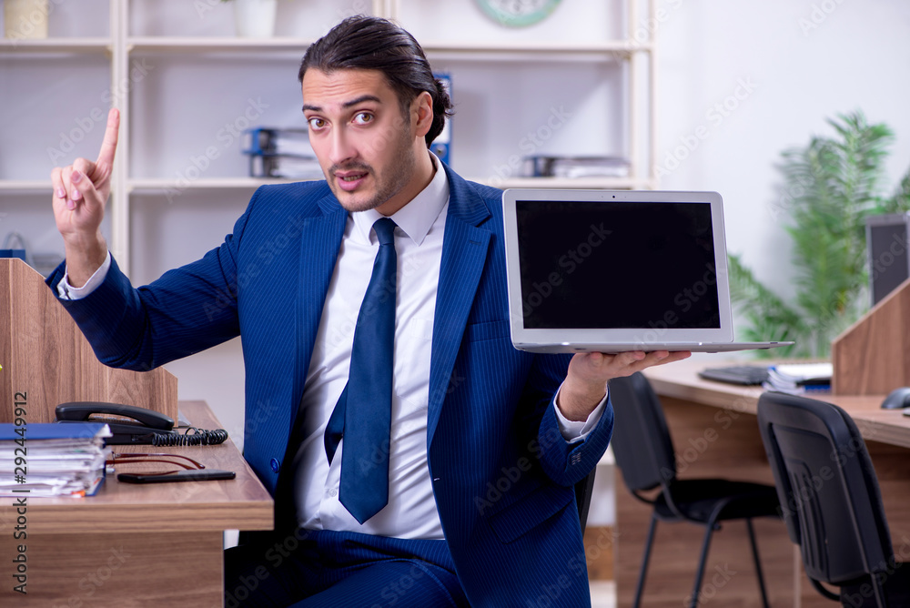 Young handsome businessman working in the office Young handsome businessman working in the office