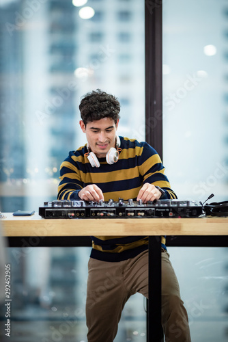 Male DJ playing music in party