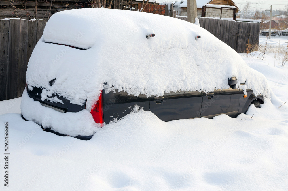 Car covered with snow in the winter snowfall Car covered with snow in the winter snowfall