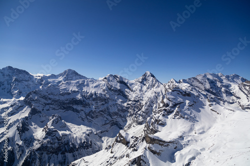 big mountain range with gigantic view in winter with blue cloudless sky