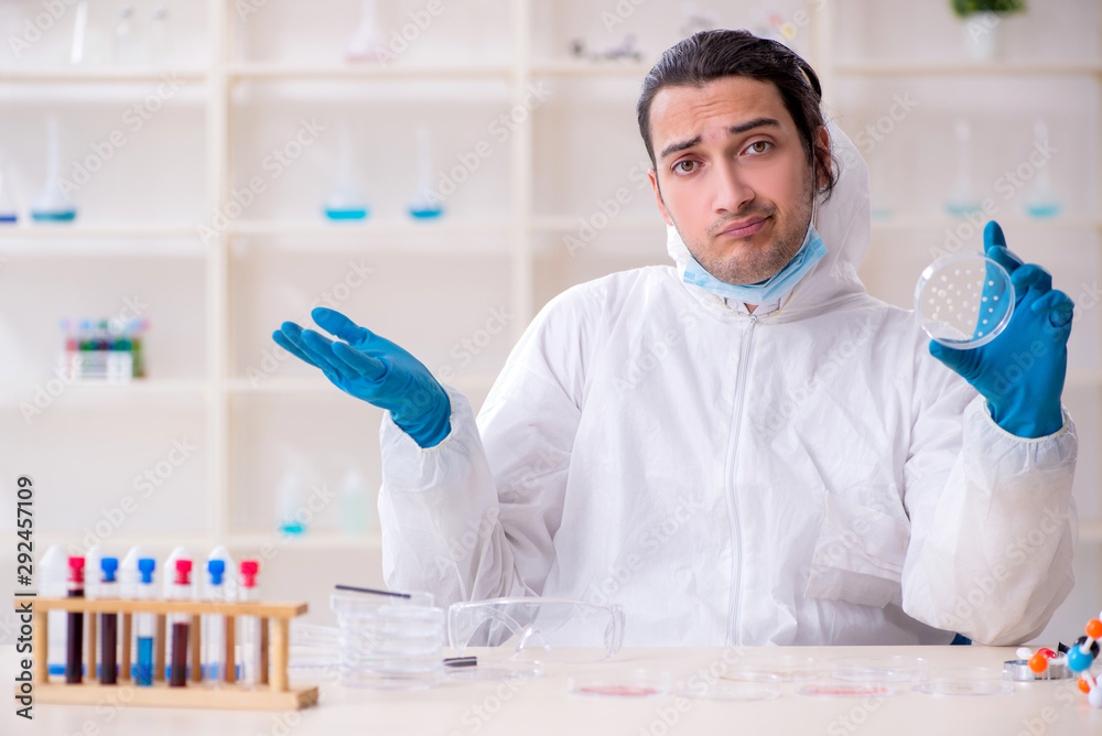Young male chemist working in the lab Young male chemist working in the lab
