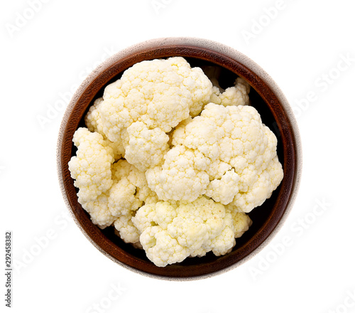 Cauliflower piece in wood bowl on white background