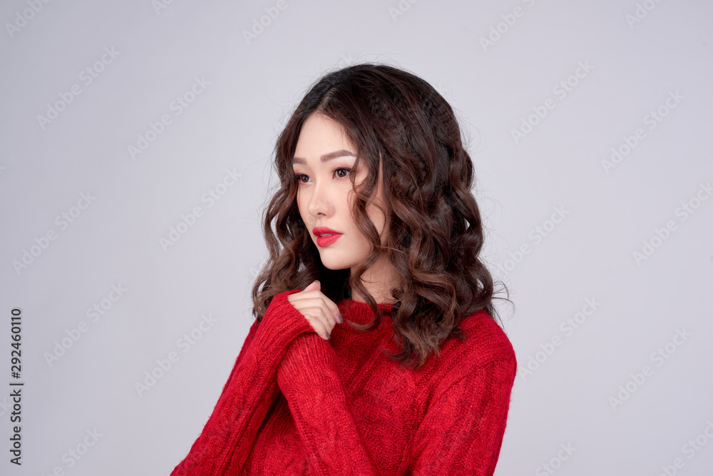 Portrait of happy woman in Red Sweater standing in anticipation. Young mixed race woman praying and looking at camera. Christmas or New Year wish concept Portrait of happy woman in Red Sweater standing in anticipation. Young mixed race woman praying and looking at camera. Christmas or New Year wish concept